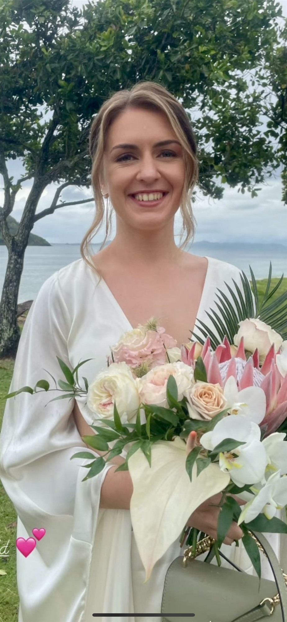 Bride at a destination wedding holding a vibrant bouquet
