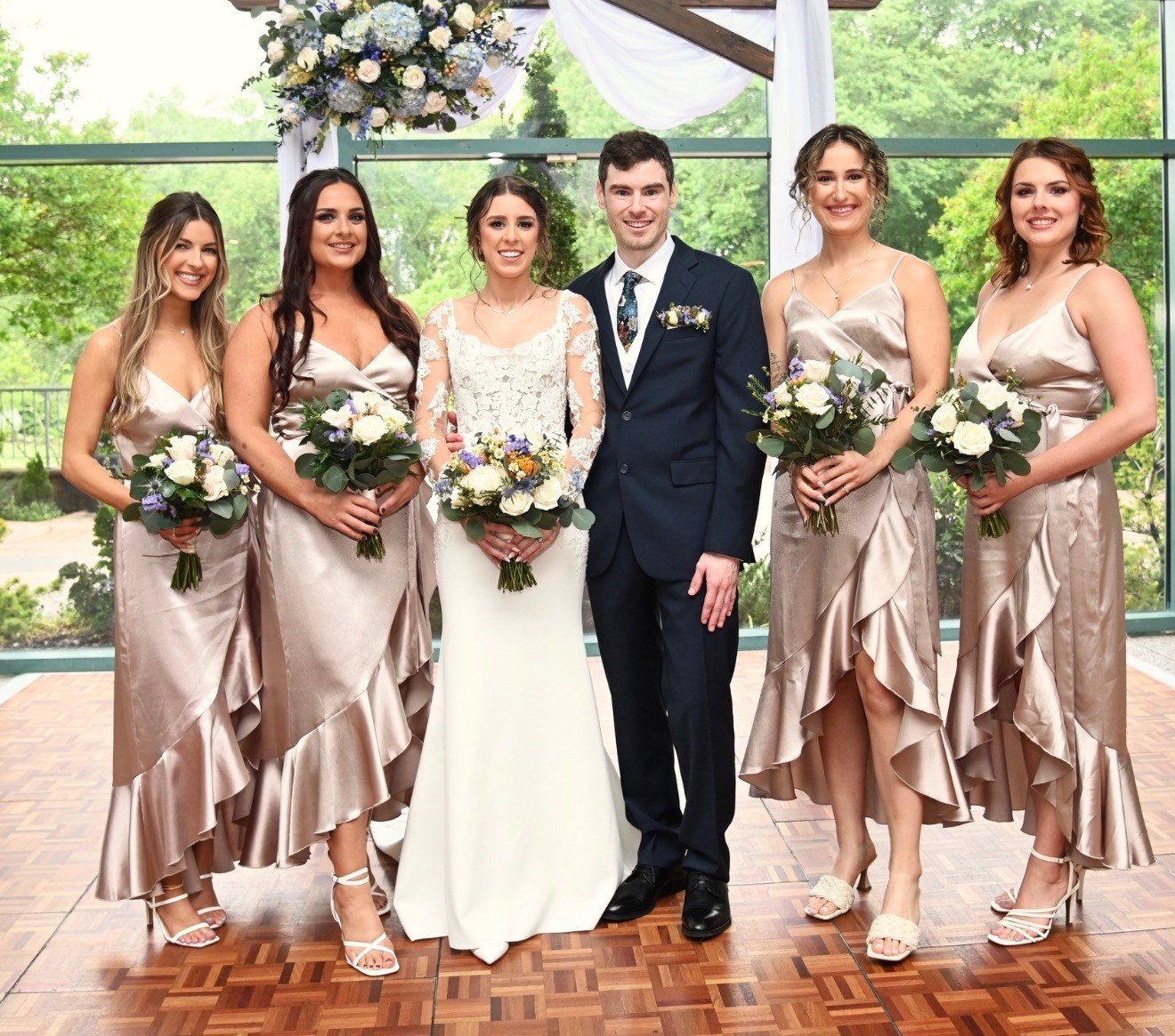 Bride and groom with bridal party in champagne gowns
