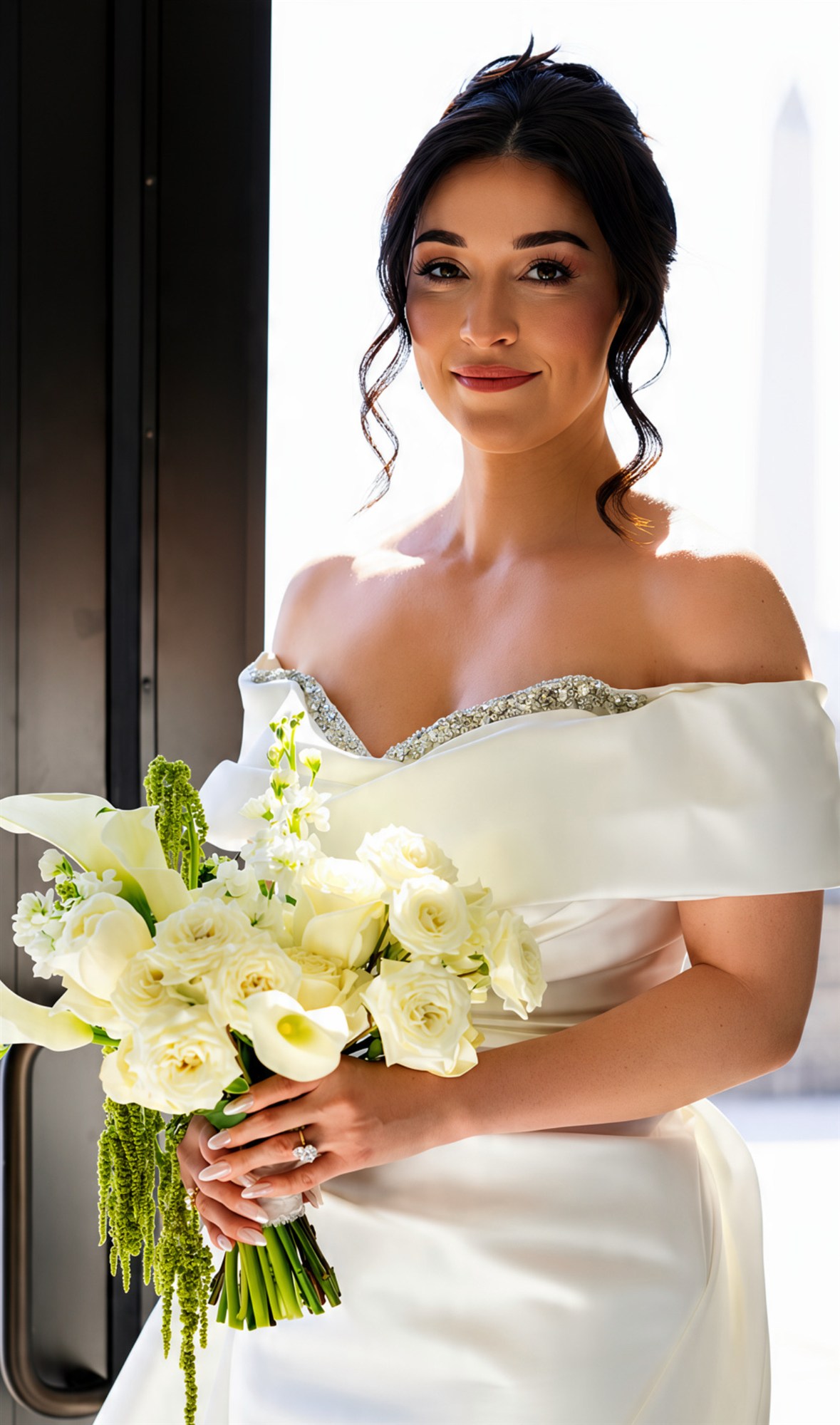 Bride in a beaded gown holding a calla lily bouquet