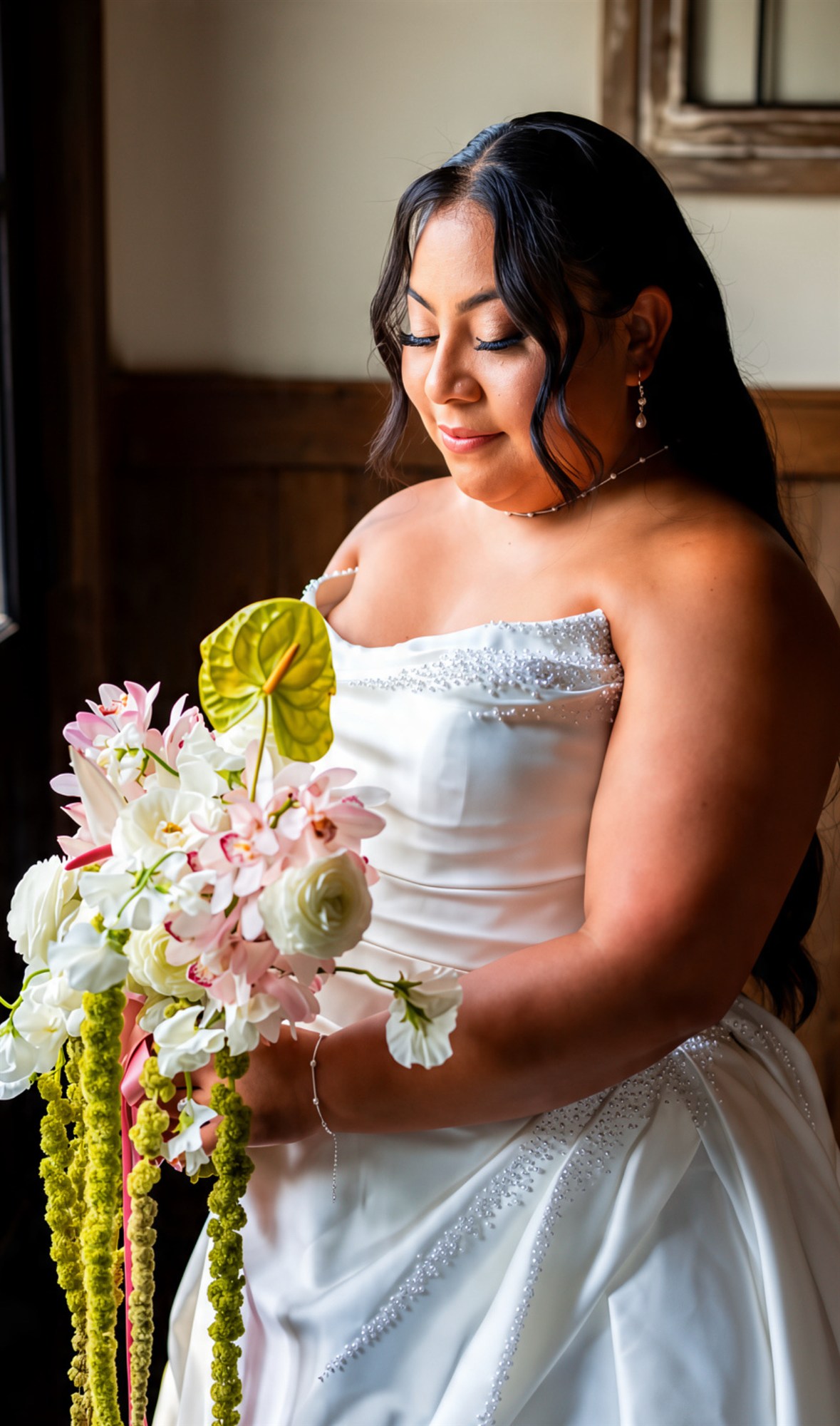 Bride holding a green anthurium and orchid bouquet