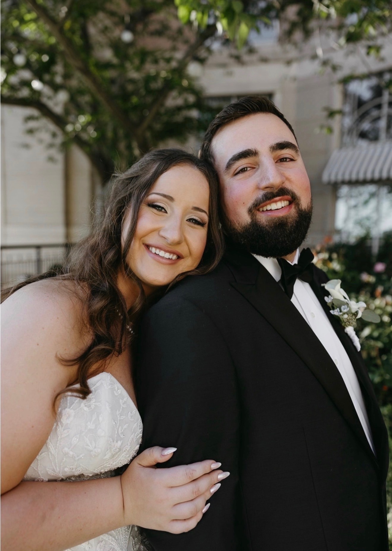 Bride and groom cheek to cheek, autumn foliage backdrop