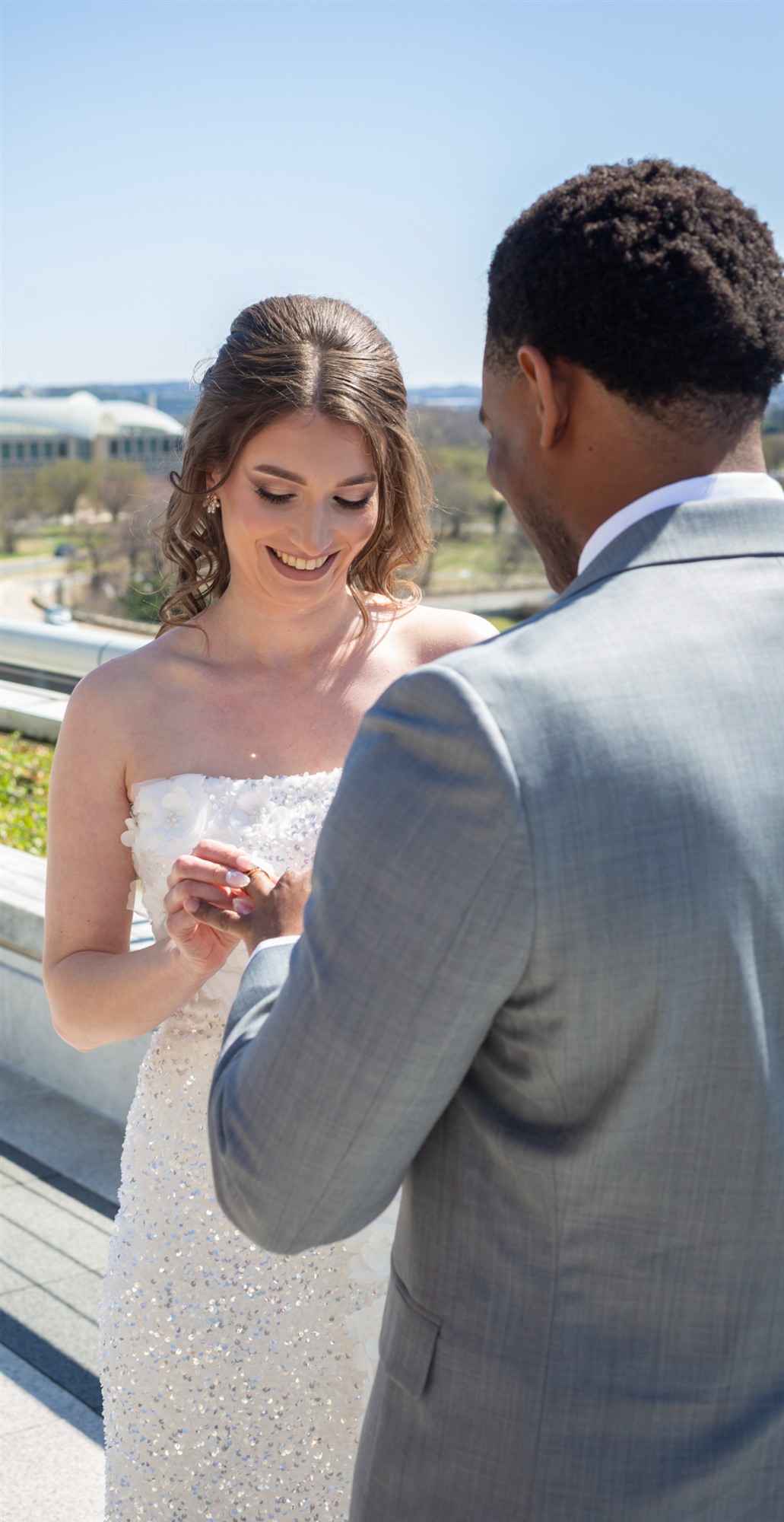 Bride and groom sharing a quiet moment on a rooftop, city skyline