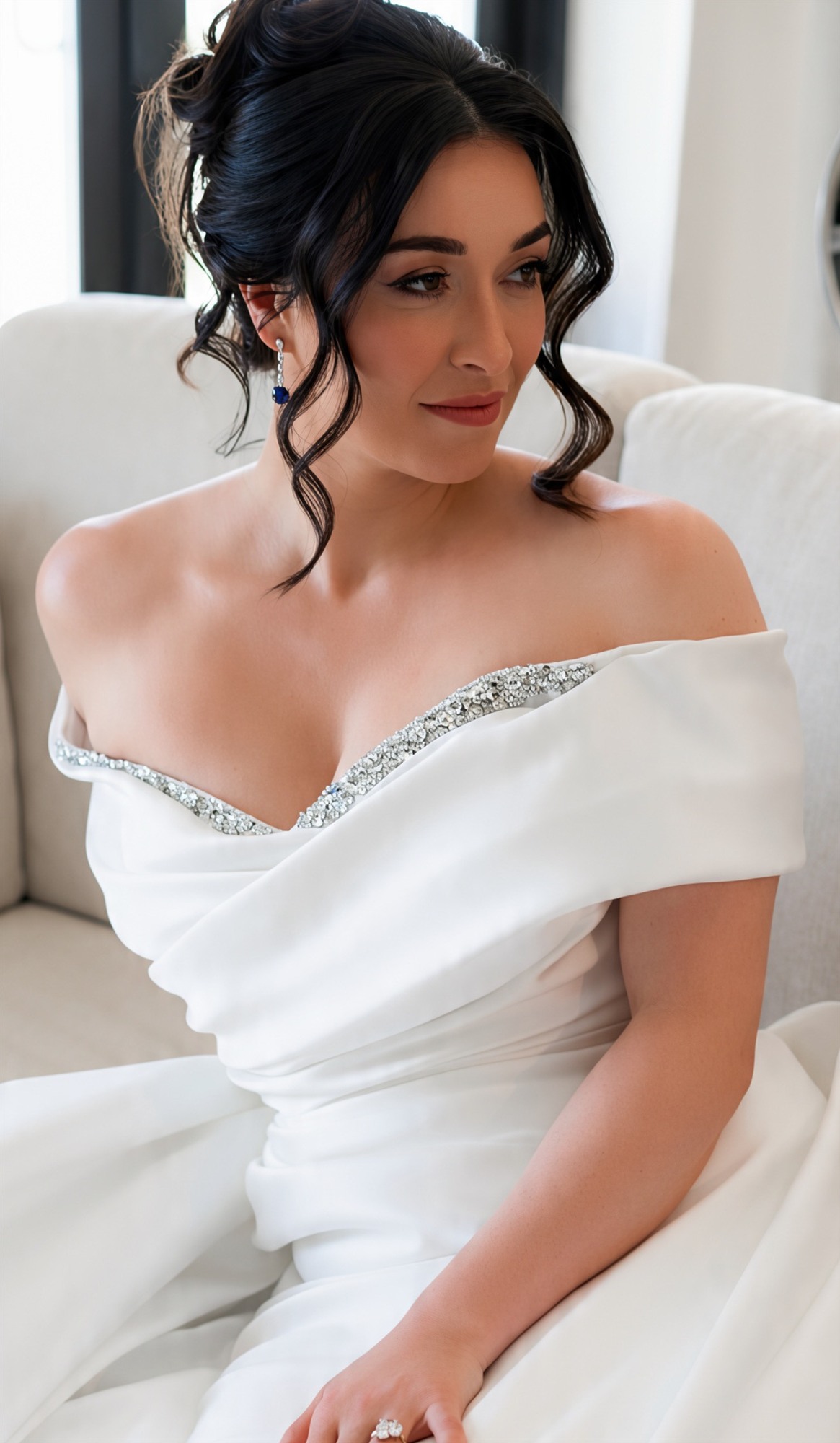 Close-up of finished bridal makeup, off-shoulder gown, soft curls