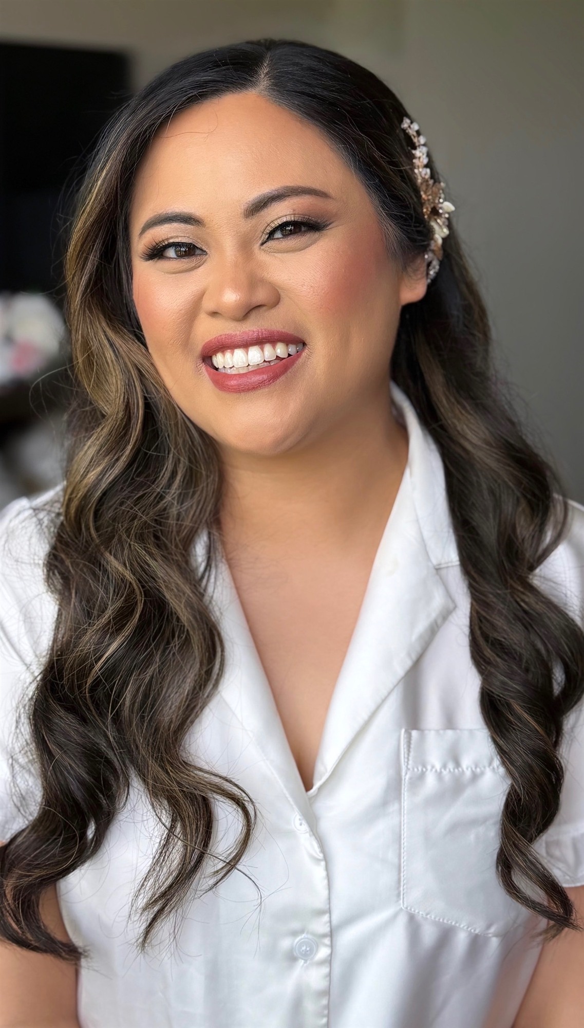 Close-up of finished bridal makeup, bride glancing over her shoulder