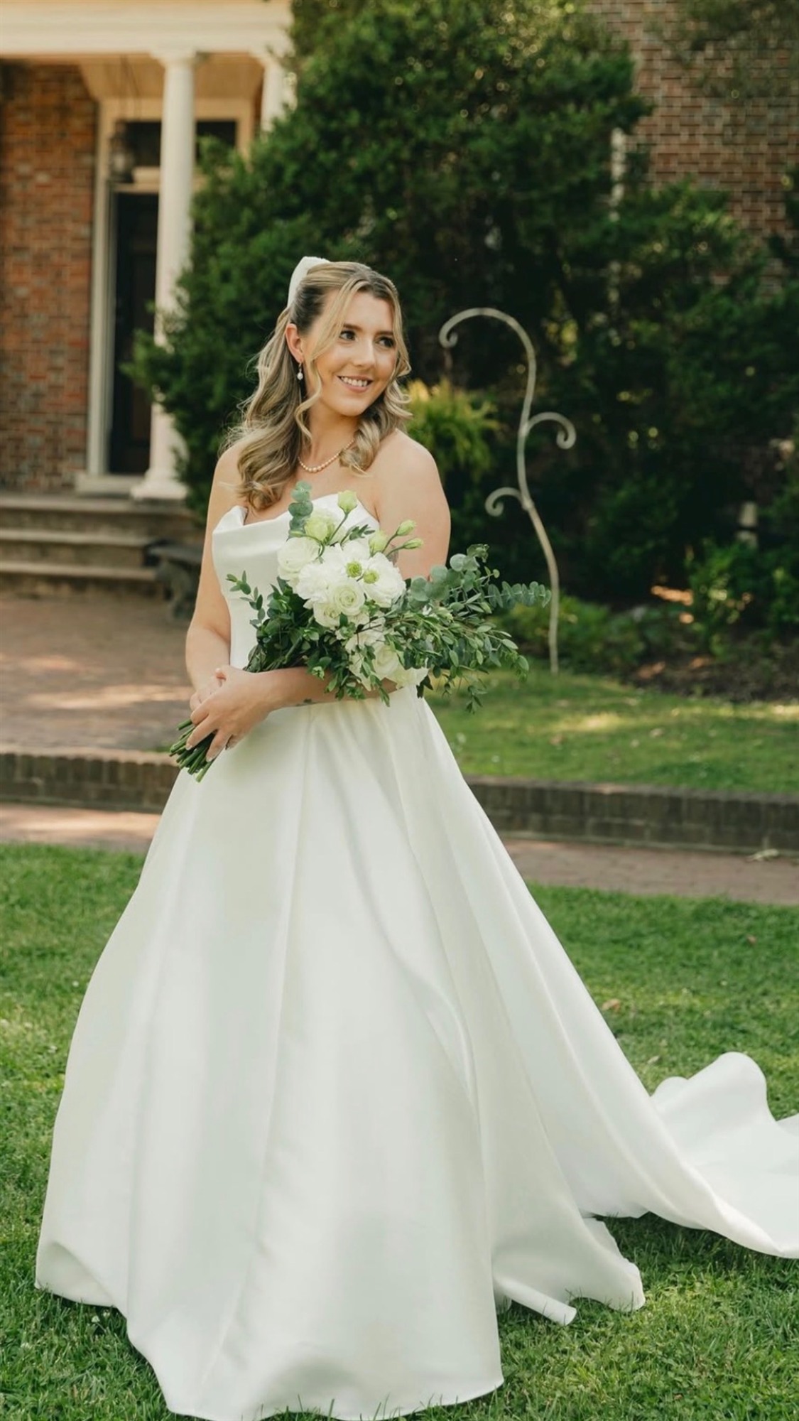 Close-up of finished bridal makeup, bride glancing aside with a smile