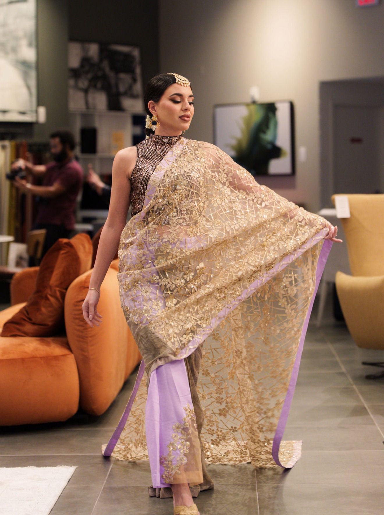 Model in a gold-embroidered saree, editorial styling, dynamic twirl
