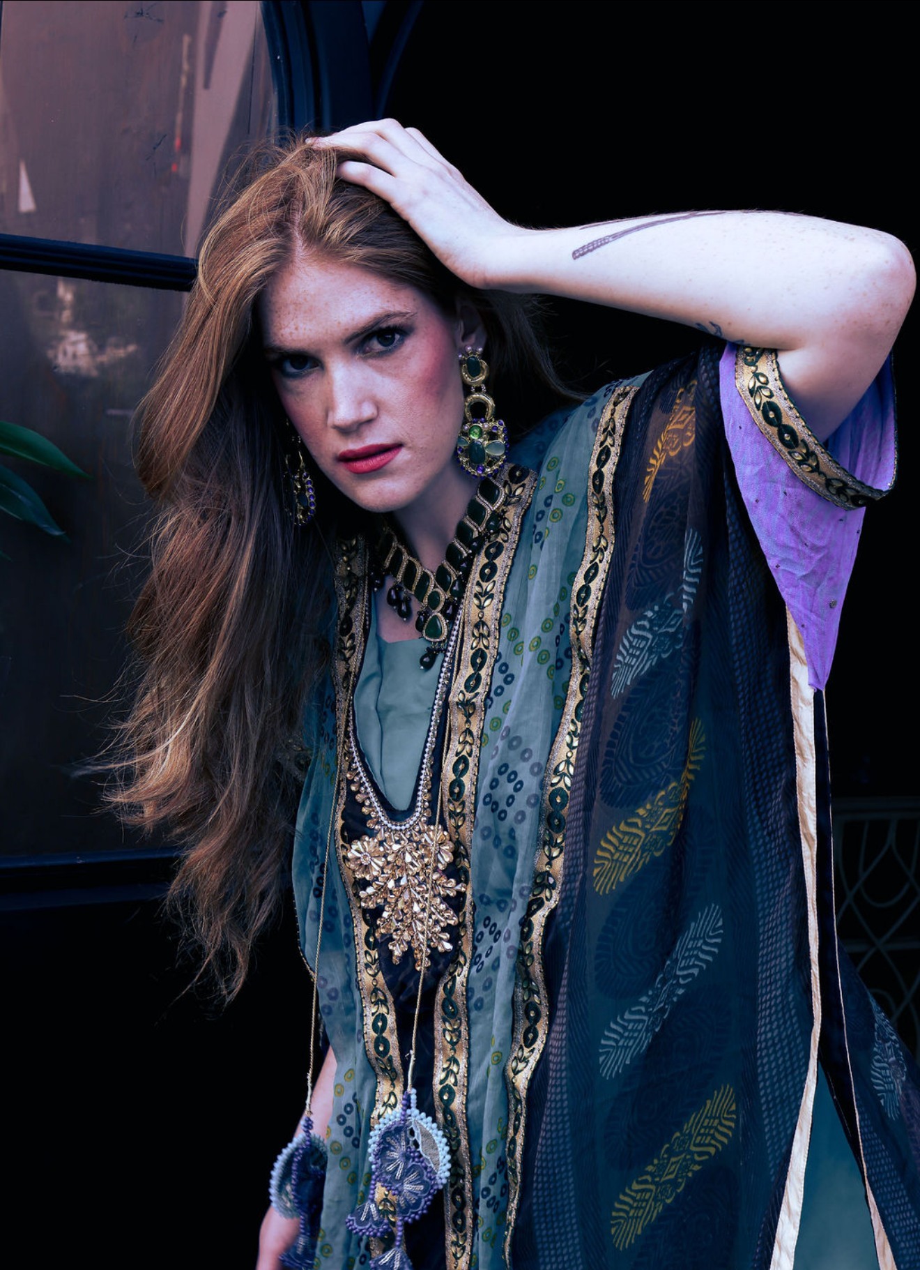 Editorial portrait in a teal and gold embroidered kaftan